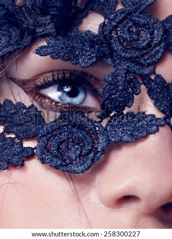 Blue eye closeup.Beautiful fashion girl with arrow make up. Closeup female eye with beautiful fashion bright makeup,lace on the face