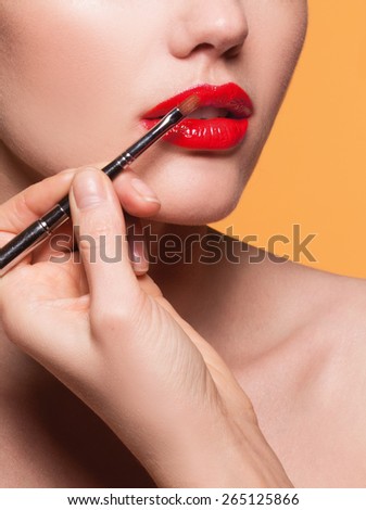 Professional Lips Make-up. Lipgloss and Brush. Lipstick. Beauty Girl Applying Lip Gloss