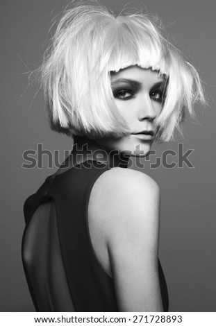 Close-up portrait of beautiful model with bright make up, on grey background fashion party style, wig