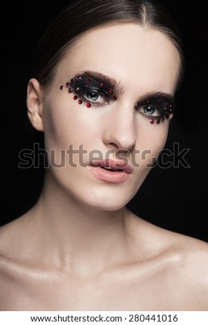 Fashion Beautiful young model with red lips, with silver glitter on her face