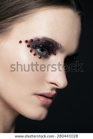 Fashion Beautiful young model with red lips, with silver glitter on her face
