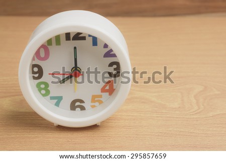 clock on a wooden:time 8 o\'clock, warm tone process.