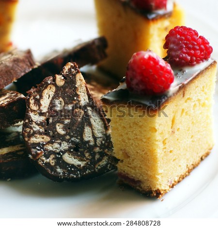 Italian desserts - chocolate salami and white chocolate cake with raspberries