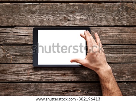 Man use a spread gesture on touch screen of digital tablet. Clipping path included.