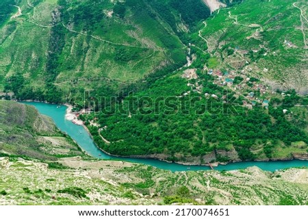 aerial view of the village of Old Zubutli in the valley of the Sulak River in Dagestan, small mountain settlement in a deep canyon with a jetty for motorboats 商業照片 © 