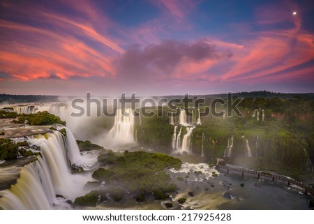 Red clouds and full moon during the sunrise at Iguassu Falls