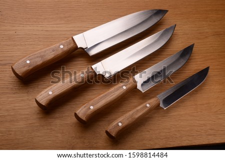 knives with a wooden handle,made of steel, steel, black steel, blades, on the procurement, a set of Japanese, Japanese knives, high-quality steel, kitchen knife. sparkle
