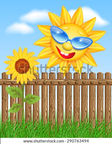 Smiling sun peeks out from behind a fence and looks at sunflowers