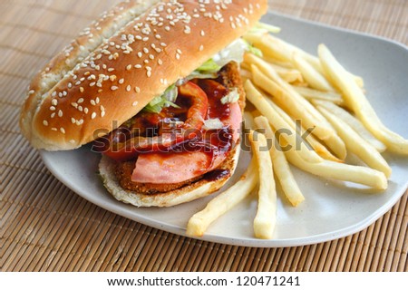 Burger with fries on bamboo mat