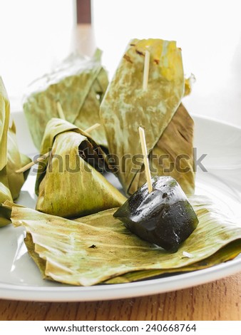 Thai caramel candy were folded by banana leaf, selective focus on the black caramel
