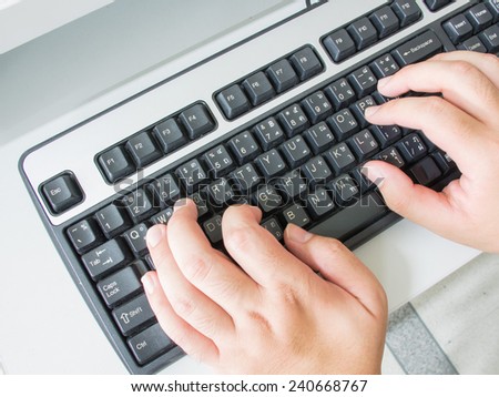 Hand typing on English-Thai computer keyboard