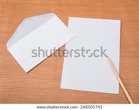 Envelope with White paper inside on wooden floor