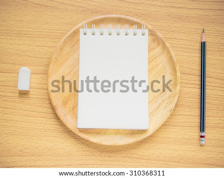 Paper note on wood dish with pencil and eraser, Concept for Menu Creation or Restaurant Commentator, Filter process.