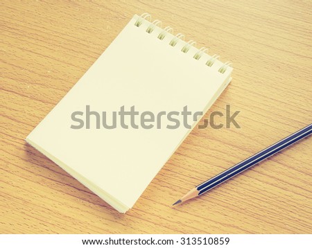 Paper note with Pencil on wooden table, Concept for Business, Education or Creative thinking. Filter process