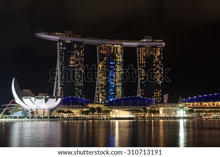 Singapore, Singapore - May 18, 2015: Marina Bay Sands hotel and ArtScience museum at night in Singapore. The hotel is a luxury resort famous for its infinity swimming pool and a landmark in Singapore.
