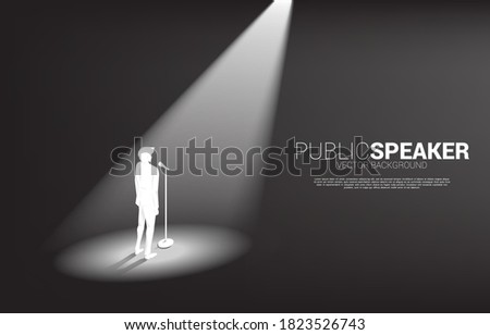 Silhouette of businessman standing with microphone. Concept of front man and public speaking.