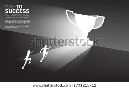 Silhouette businessman running in light from exit door shape trophy. Business Concept of route to winner and champion