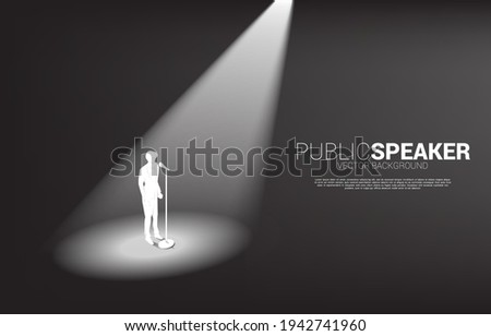 Silhouette of businessman standing with microphone. Concept of front man and public speaking.