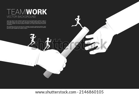 Silhouette of Businessman and businesswoman running on hand passing baton in relay race between businessman. Business concept for teamwork and partnership