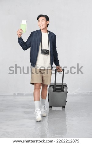 Similar – Image, Stock Photo Asian man with travel bag using smartphone against white wall