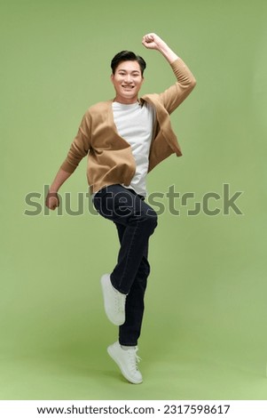 Similar – Image, Stock Photo Handsome young man jumping against grey wall