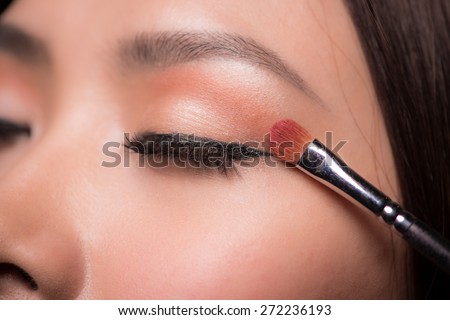 Eye makeup woman applying eyeshadow powder. Makeup. Make-up. Eyeshadows. Eye shadow brush