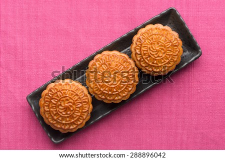 Chinese mid autumn festival foods. Traditional mooncakes on table setting.