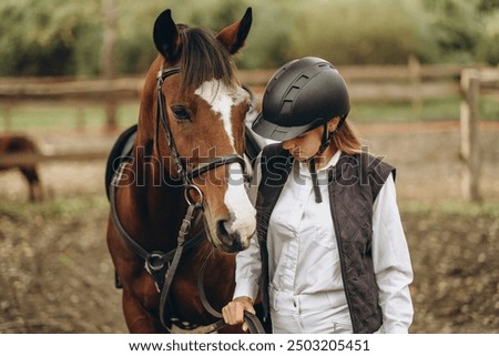 Similar – Image, Stock Photo Woman in jockey outfit standing with horse