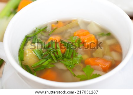 vegetable soup in white soup bowl, closeup, aerial view, landscape format