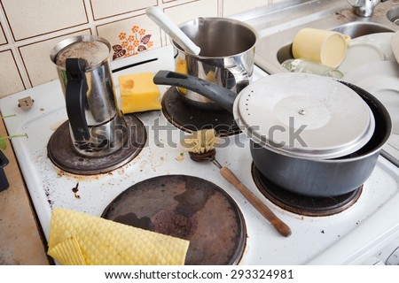 messy stove in domestic kitchen with grungy dishware, old pot and espresso maker, with dirty and used scrubber and yellow sponge