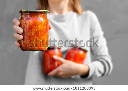 Lecho. Lecsó. Tinned tomatoes with peppers. Conservation in hand close up Stock fotó © 