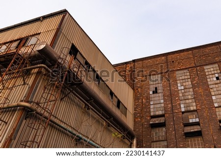 Similar – Image, Stock Photo Old industrial building with street and cheerful pennant shadow