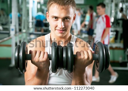 Man with weight training equipment on sport gym club