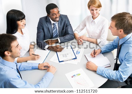 Business group meeting portrait - Five business people working together. A diverse work group.