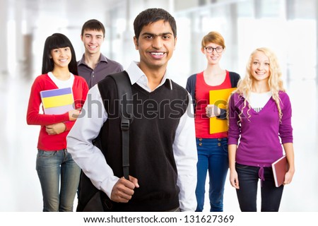 Young indian student and his diversity friends on background