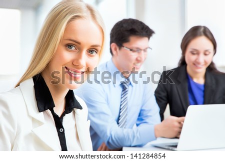Business woman and her collegues working together in an office