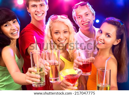 Happy people clinking glasses with each other