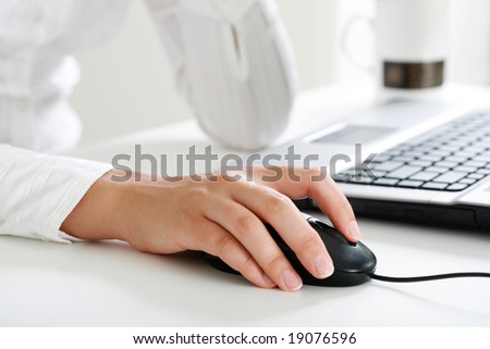 Image of female hand touching computer mouse
