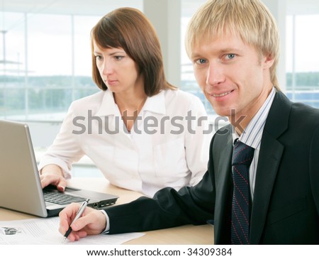 Businessman and businesswoman work in team