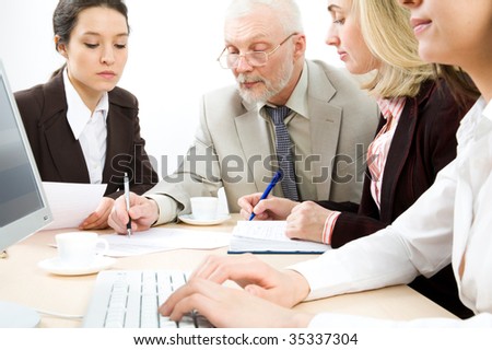 Four business people working in an office, white and black
