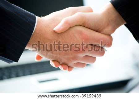 Business people joining hands together for deal