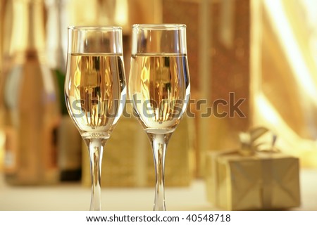 Glasses of champagne with gold gifts . Christmas.