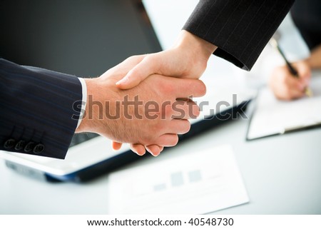 Business people joining hands together for deal