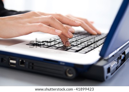Female hands typing a letter on the laptop
