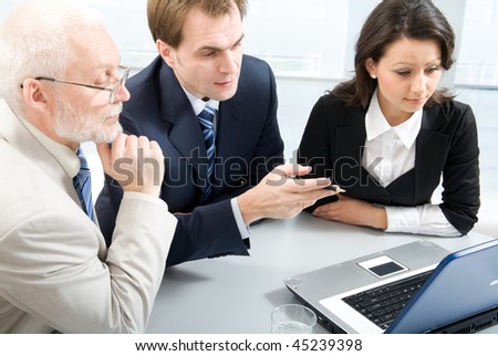 Three business people working with lap-top