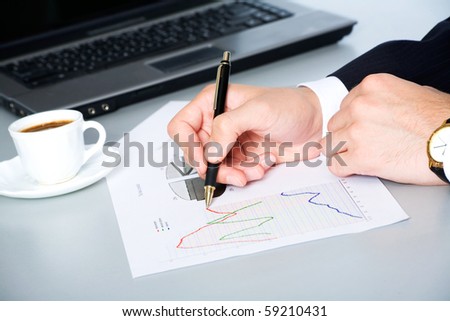 Close-up of business man hands over papers discussing them