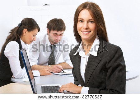 Portrait of businesswoman looking at camera in working environment