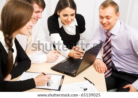 Image of four business people working at meeting