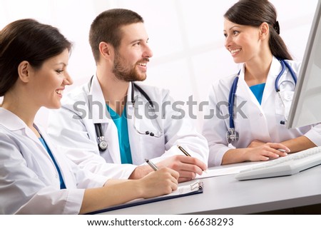 Smiling medical doctors talk on a workplace