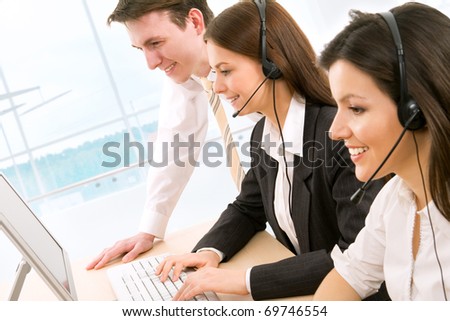 Telephone operators looking at the monitors and working